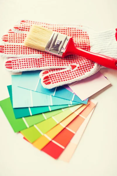 Paintbrush, gloves and pantone samplers — Stock Photo, Image