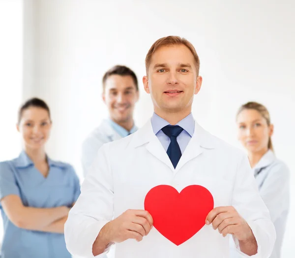 Smiling male doctor with red heart — Stock Photo, Image