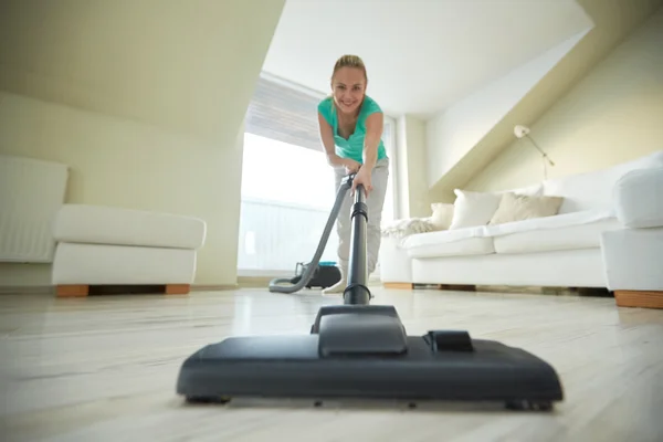 Happy woman with vacuum cleaner at home — Stock Photo, Image