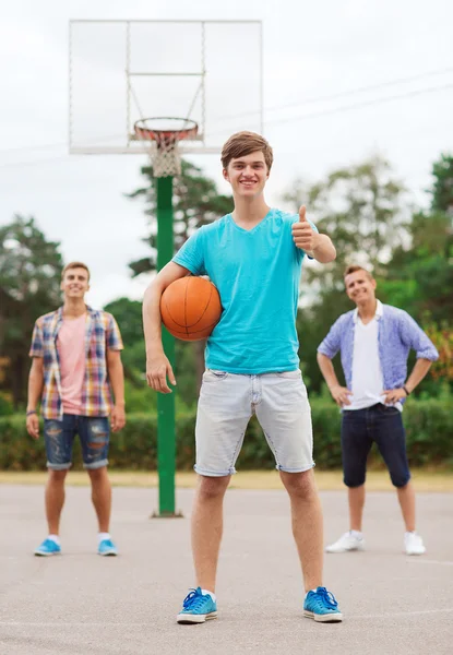 Группа улыбающихся подростков, играющих в баскетбол — стоковое фото