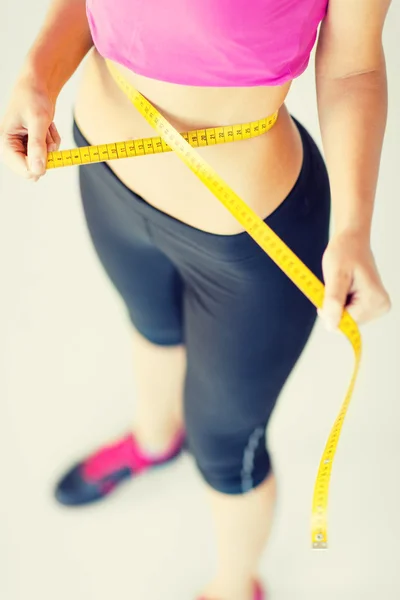 Trained belly with measuring tape — Stock Photo, Image