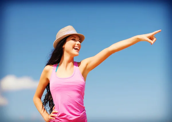 Girl  showing direction on  beach — Stock Photo, Image