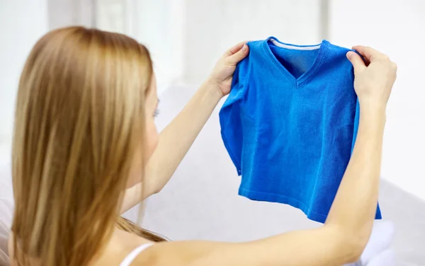 woman holding little boys pullover