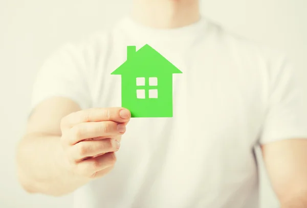 Hand holding green house — Stock Photo, Image