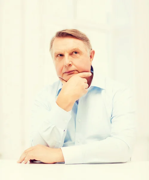 Stressed old man holding head — Stock Photo, Image