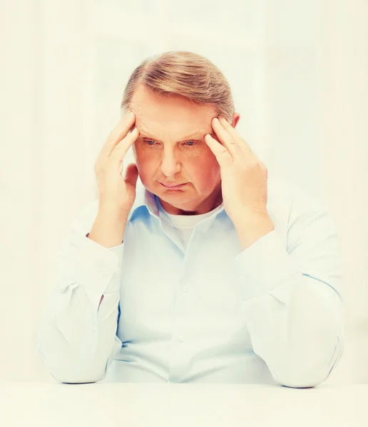 Stressed old man holding head — Stock Photo, Image
