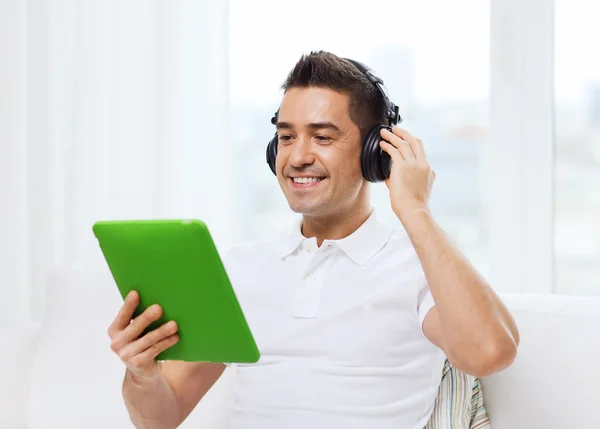 Hombre con tablet PC y auriculares — Foto de Stock