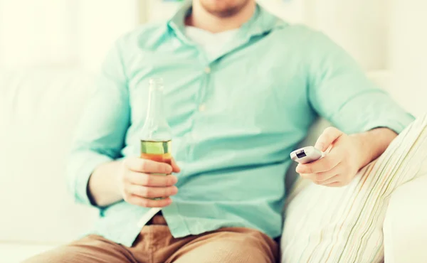 Man with beer and remote control — Stock Photo, Image