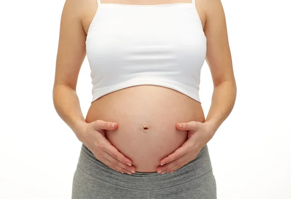 Pregnant woman touching her  tummy Stock Image