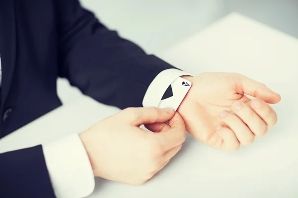 Mans hand hiding ace in the sleeve — Stock Photo, Image