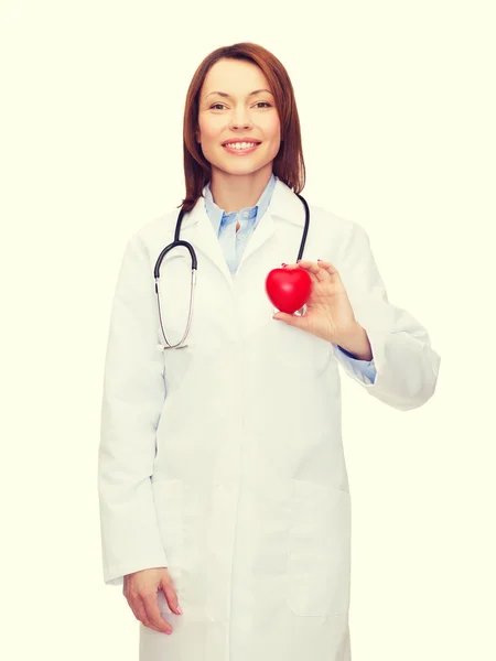 Smiling female doctor with heart and stethoscope — Stock Photo, Image