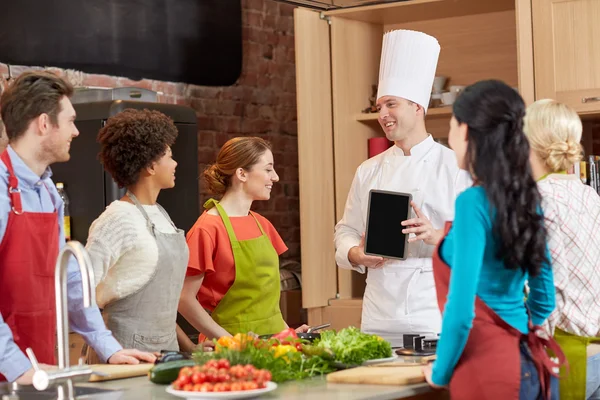 Friends with chef   in kitchen — Stock Photo, Image