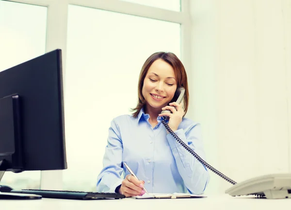 Businesswoman with laptop, files and telephone — Stock Photo, Image