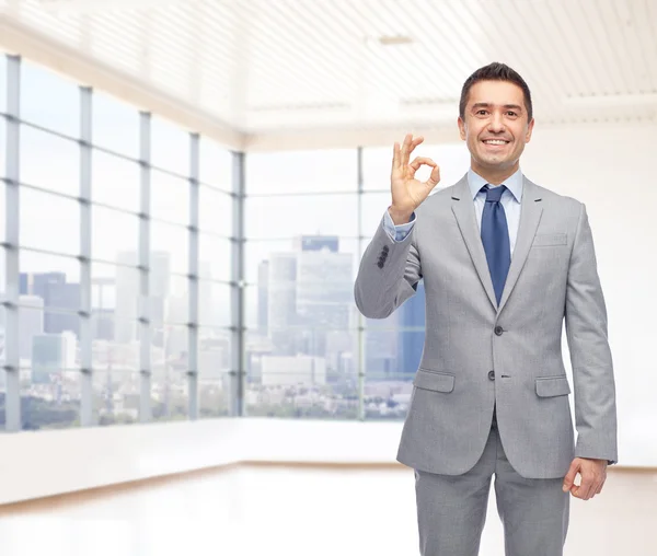 Happy businessman in suit showing ok hand sign — Stock Photo, Image