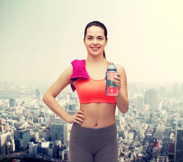 Sportliche Frau mit Handtuch und Wasserflasche — Stockfoto