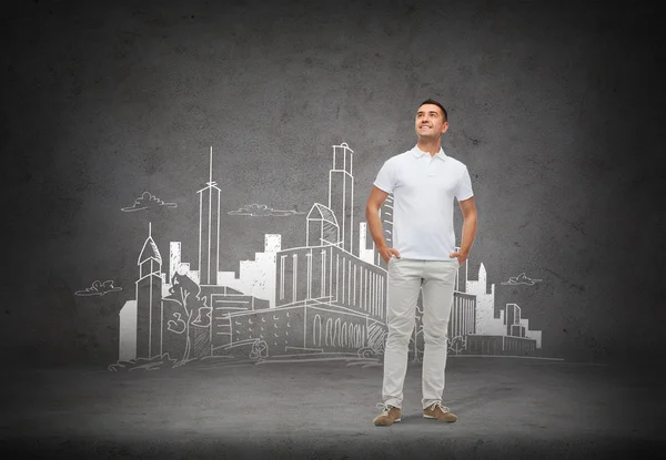 Smiling man over city sketch background — Stock Photo, Image