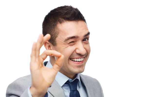 Hombre de negocios feliz en traje mostrando signo de mano ok —  Fotos de Stock