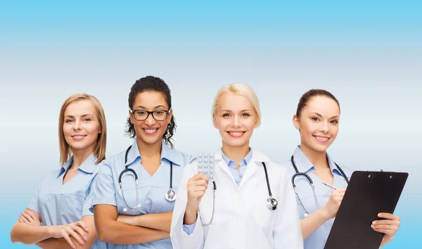 Smiling female doctor and nurses with stethoscope — Stock Photo, Image