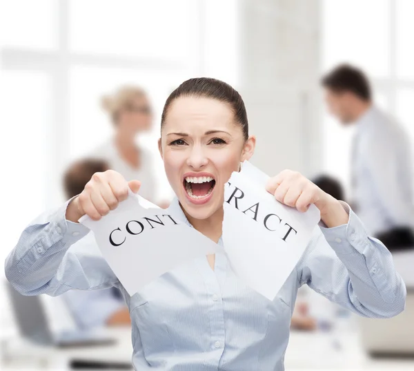 Serious businesswoman tearing contract — Stock Photo, Image