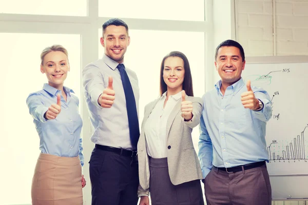 Equipo de negocios mostrando pulgares hacia arriba en la oficina —  Fotos de Stock