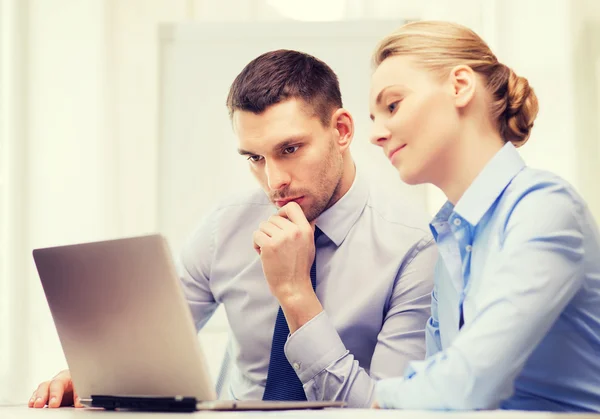 Serious business couple with laptop computer — Stock Photo, Image