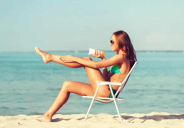 Sorrindo jovem mulher tomando banho de sol no salão na praia — Fotografia de Stock