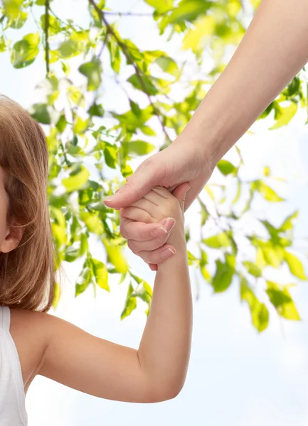 Close up of woman and little girl holding hands — Stock Photo, Image