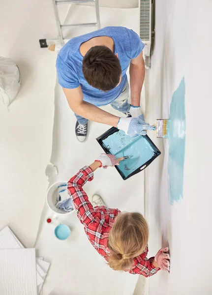 Close up of couple painting wall at home — Stock Photo, Image