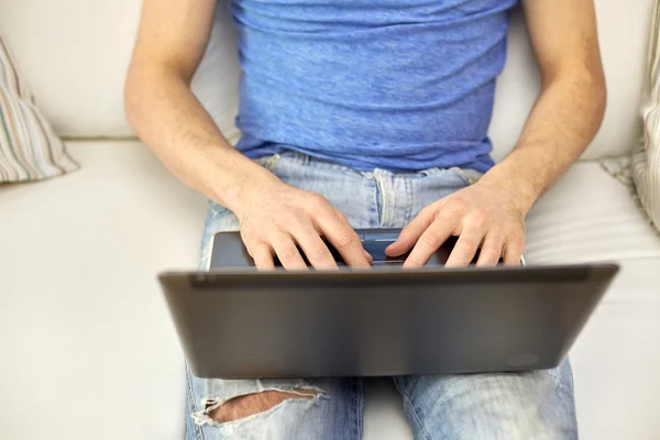 Close up of man typing with laptop at home — Stock Photo, Image