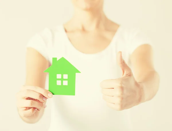 Woman hands holding green house — Stock Photo, Image