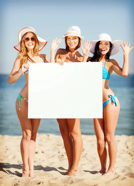 Girls with blank board on the beach — Stock Photo, Image