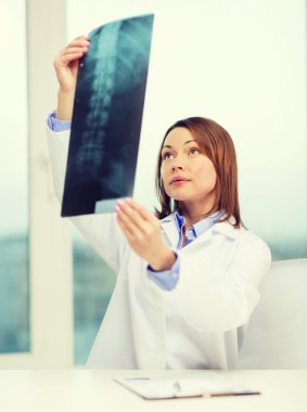 concentrated doctor looking at x-ray clipart