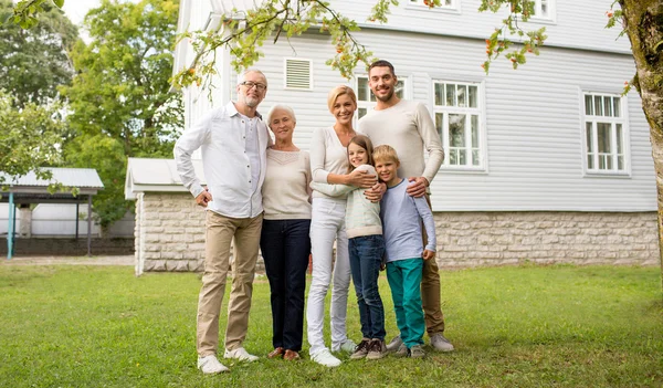 Happy family in front of house outdoors — Stock Photo, Image