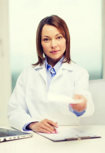 Busy doctor with laptop computer and clipboard — Stock Photo, Image