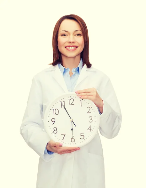 Χαμογελώντας γυναίκα γιατρό με ρολόι τοίχου — Φωτογραφία Αρχείου