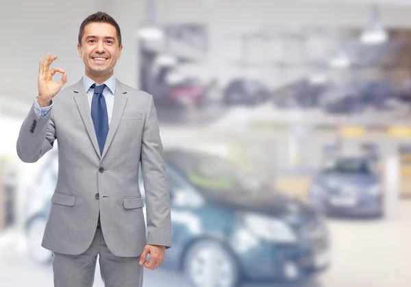 Homem feliz no auto show ou salão de beleza do carro — Fotografia de Stock