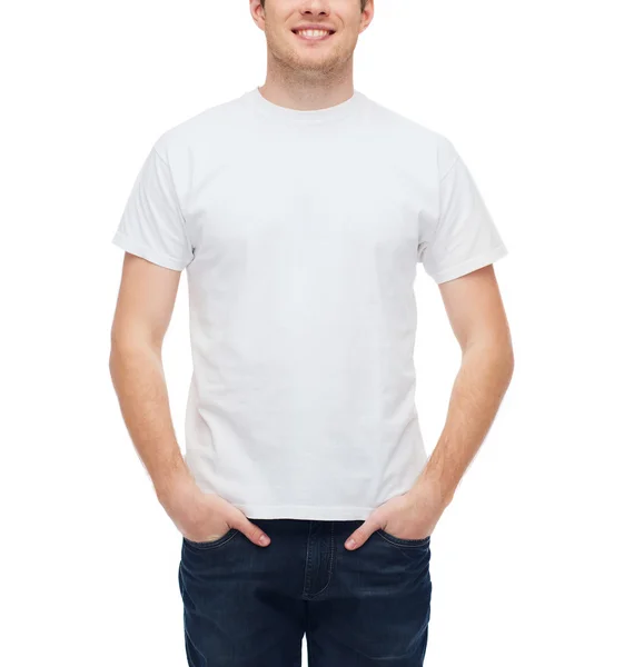 Улыбающийся молодой человек в белой футболке — стоковое фото