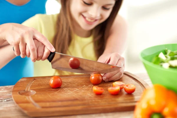 Close up of happy family making dinner in kitchen — Stock Photo, Image