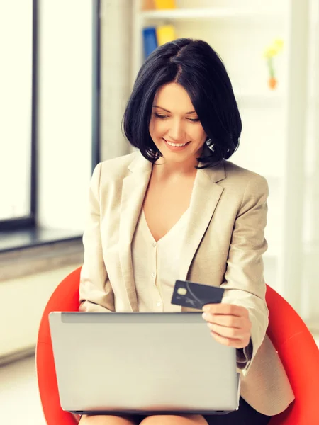 Happy woman with laptop computer and credit card Royalty Free Stock Images