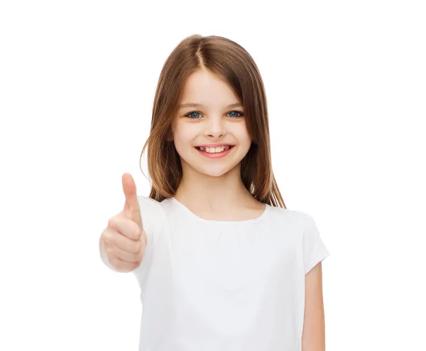 Petite fille en blanc vierge tshirt montrant thumbsup Photo De Stock