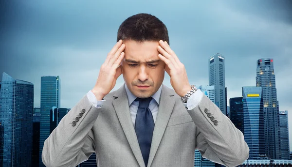 Businessman in suit having head ache — Stock Photo, Image