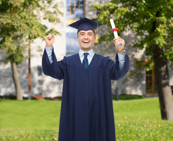 Lachende volwassen student in mortarboard met diploma — Stockfoto