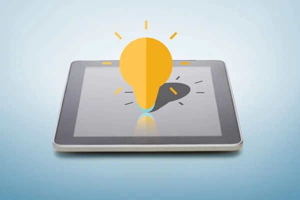 Tablet pc with lightning bulb icon over screen — Stock Photo, Image