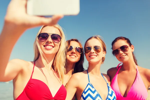 Grupa kobiet uśmiechający się co selfie na plaży — Zdjęcie stockowe