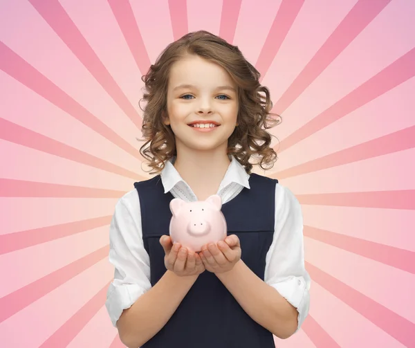 Happy girl holding piggy bank on palms — Stock Photo, Image