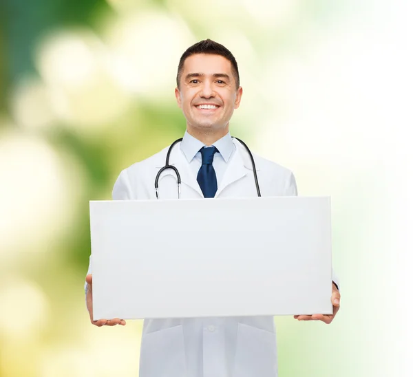 Smiling male doctor holding white blank board — Stock Photo, Image