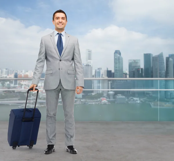 Happy businessman in suit with travel bag — Stock Photo, Image