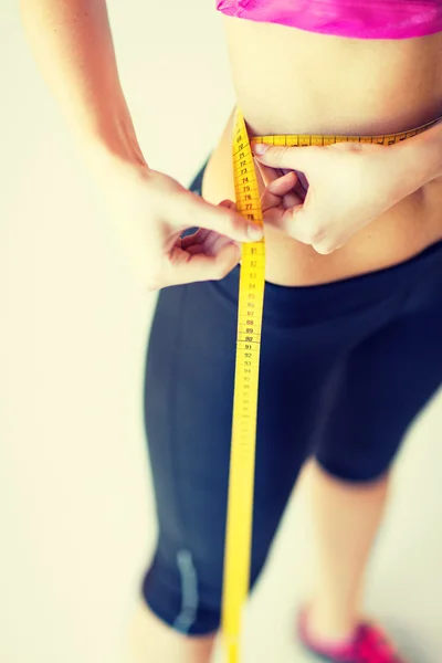 Trained belly with measuring tape — Stock Photo, Image