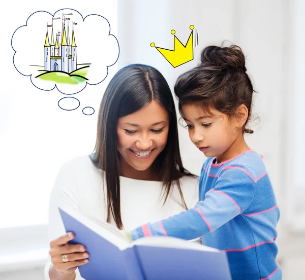 happy mother and daughter reading fairytale book