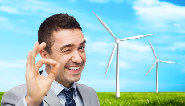 Happy businessman in suit showing ok hand sign — Stock Photo, Image